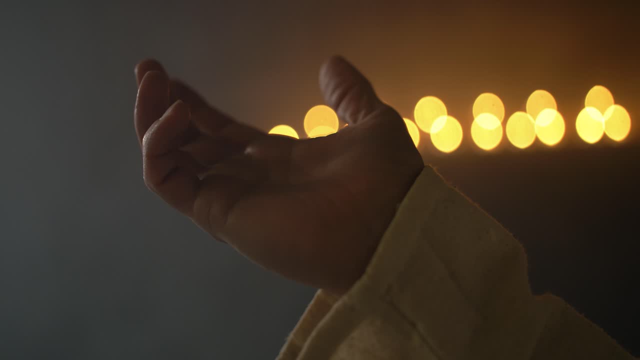 Closeup of hand lifted in prayer, worship, for Christianity stock footage