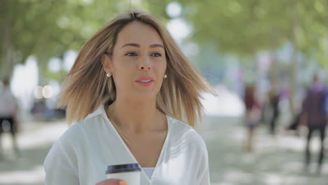 Girl-with-coffee-to-go-walking-on-street