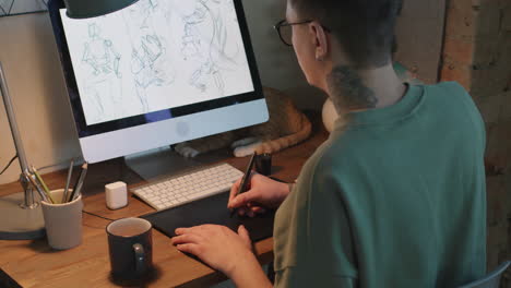 male graphic designer drawing sketches with tablet