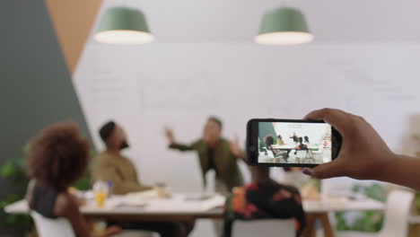 Gente-De-Negocios-Feliz-Celebrando-El-éxito-Del-Equipo-Corporativo-Disfrutando-De-La-Victoria-Gerente-Mujer-Colega-Emocionada-Usando-Un-Teléfono-Inteligente-Tomando-Un-Video-De-Una-Presentación-Compartida-En-Las-Redes-Sociales