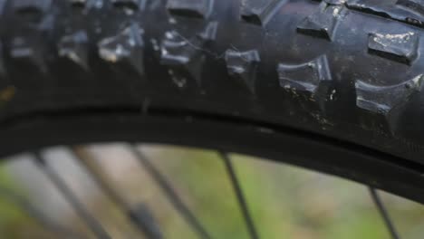 close up macro shot of bike tyre. bicycle wheel, round rubber steel concept.