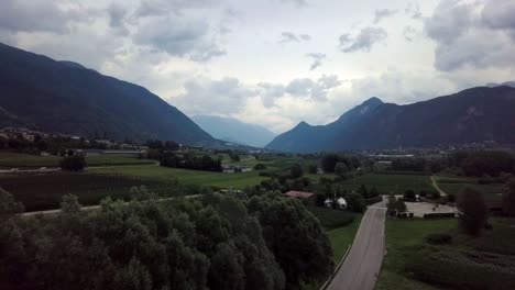 Aerial-panoramic-view-of-Levico-Terme,-Italy,-during-sunrise-with-views-of-the-mountains