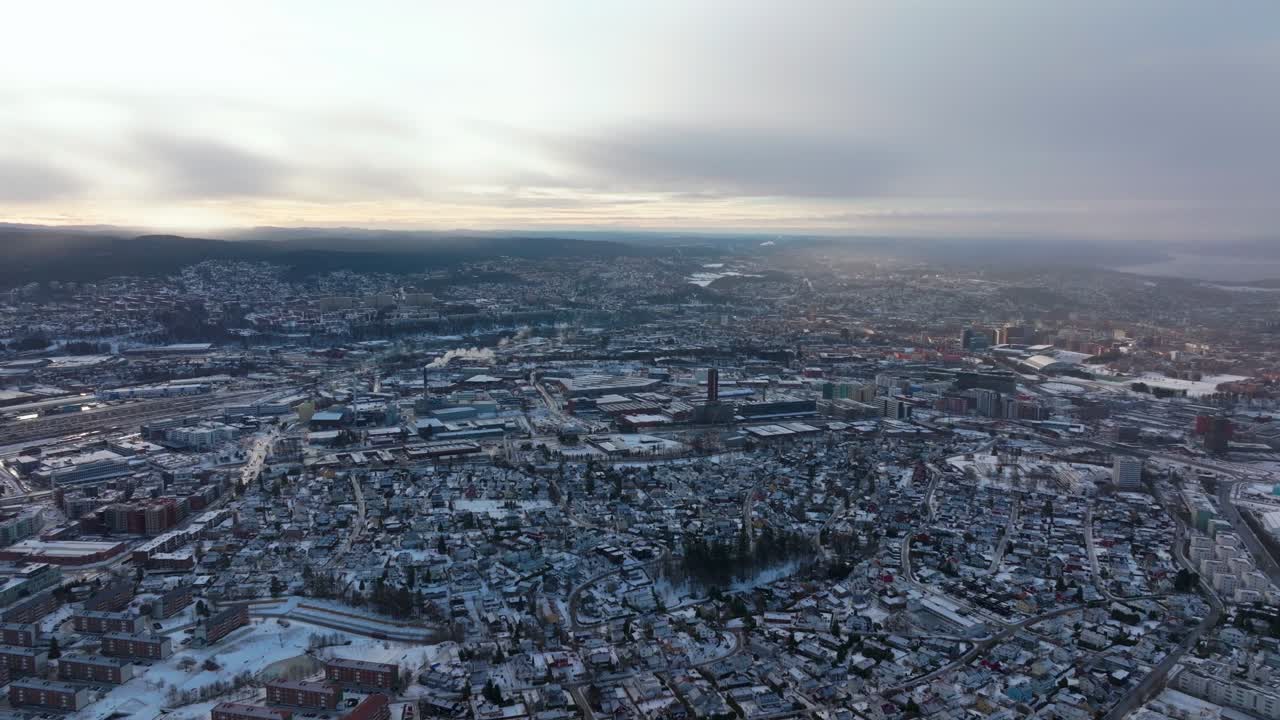 Tonsengagen Bjerke Arvoll Oslo Norge Norway aerial drone morning neighborhood apartment condominiums buildings cars traffic snowing snow flakes cold cloudy winter day gray skies city pan left motion