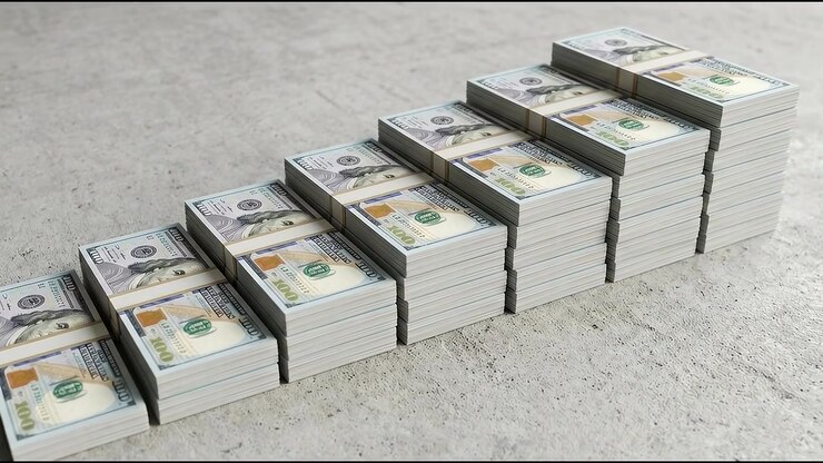 Person organizing large amount of cash in office