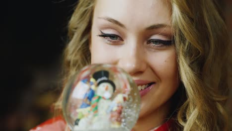 a woman looks at a toy ball