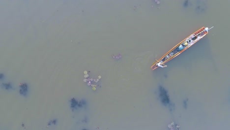 a man in a boat paddling on a lake in thailand