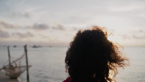 woman watching the sunset on a tropical beach