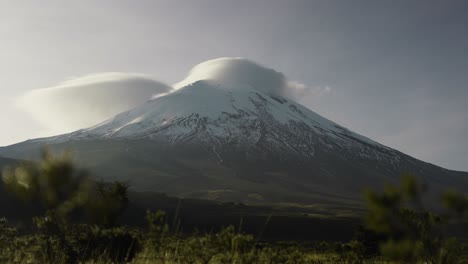 Dawn-at-great-snow-capped-volcano-forming-clouds-In-the-Andes-of-Ecuador-Cotopaxi