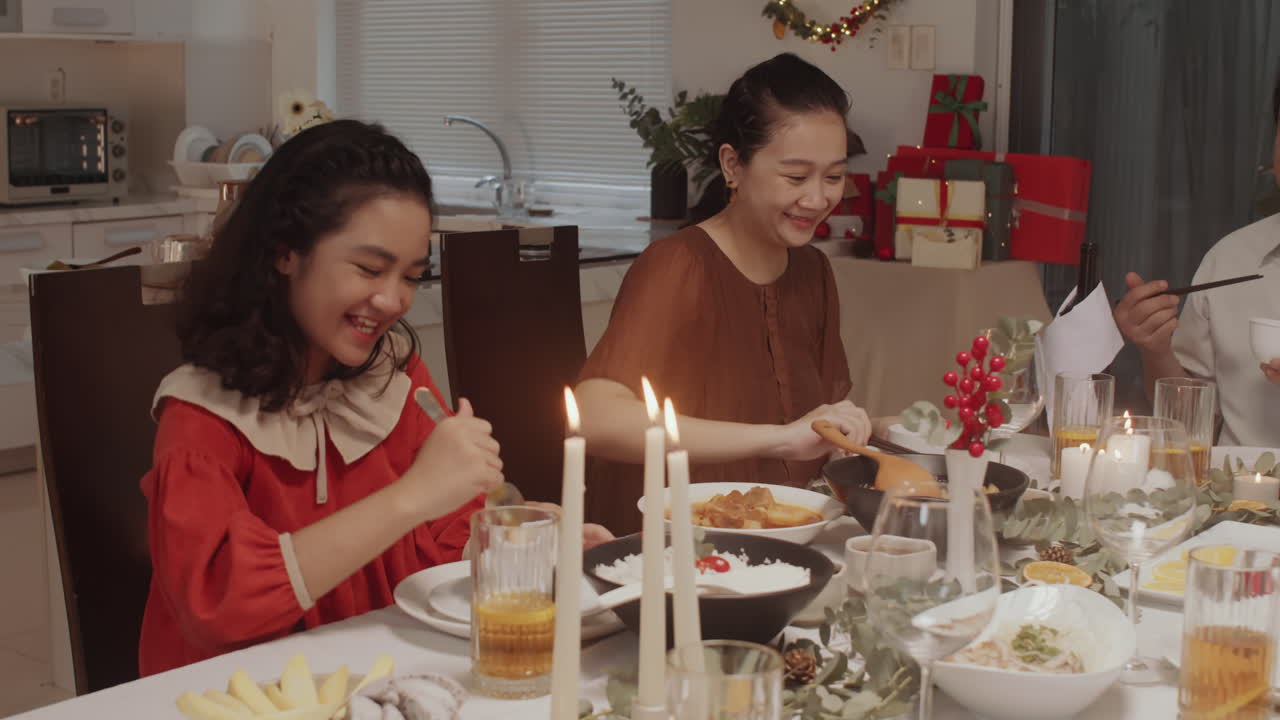 Parents Dining with Daughter at Christmas Table