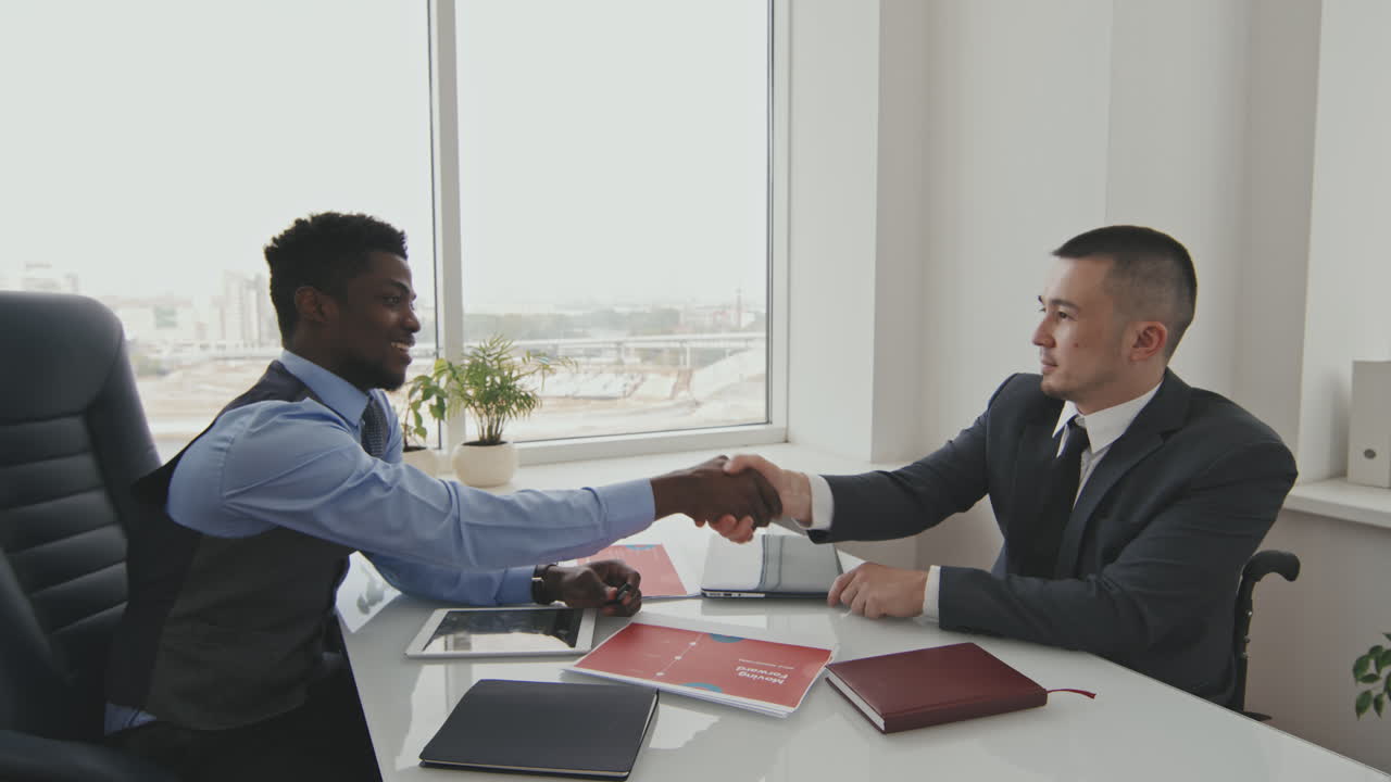 Businessmen Shaking Hands in Office