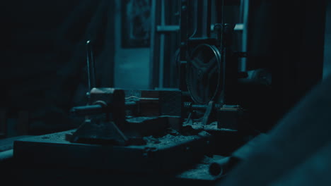 Mysterious man in the workshop at night smokes a cigarette