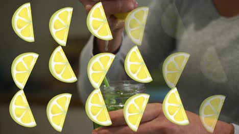 Animation-of-lemon-icons-over-caucasian-woman-making-healthy-drink