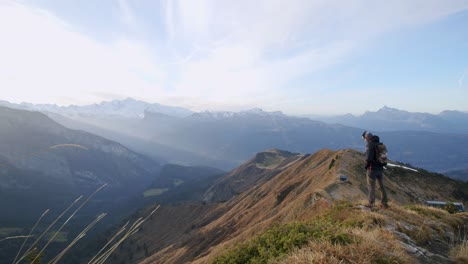 a man is looking at the view from the top of a mountain in autumn