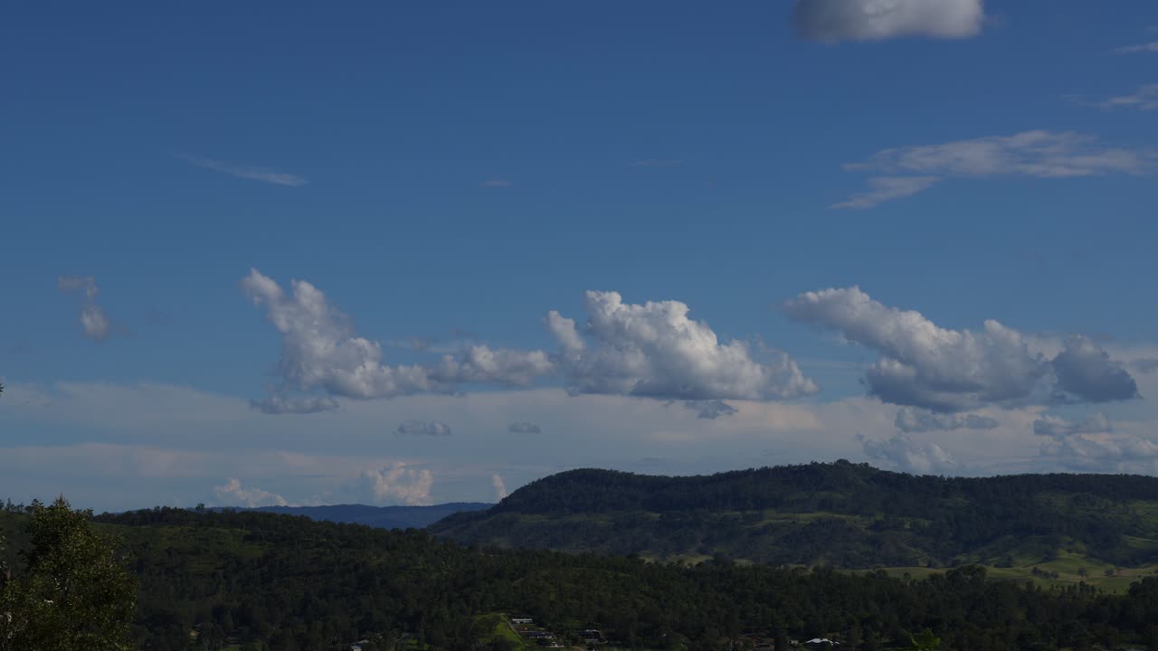 평화로운 산악 풍경 위에 움직이는 구름