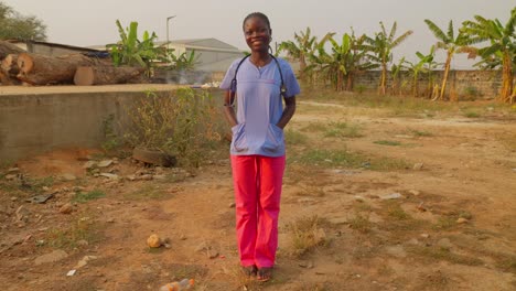 portrait of happy african doctor put hand in pocket of coat lab standing and smiling in front of camera in remote village clinic hospital