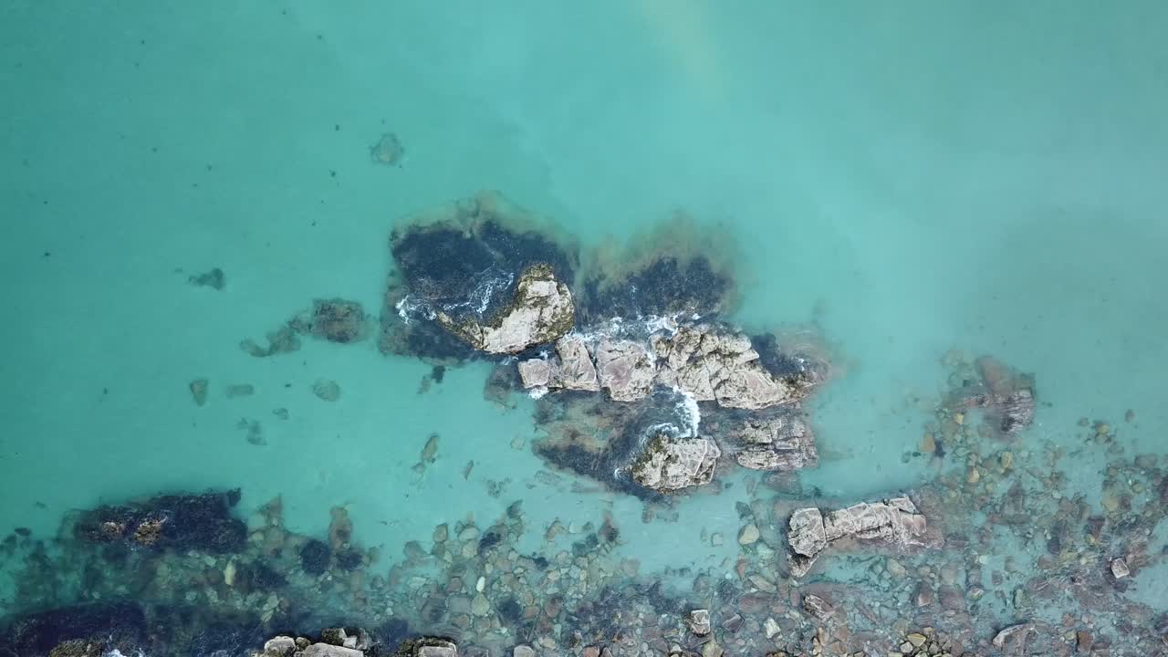 Drone Footage of Ocean Waves Crashing Against Rock with Seagull Flying Overhead