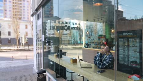 woman working on a laptop in a cafe