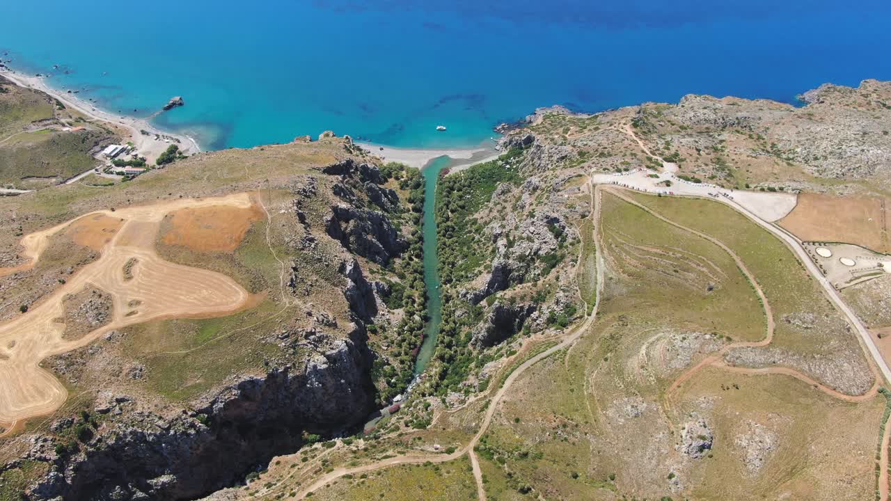 Aerial drone panoramic view of Panorama of Preveli beach at Libyan sea, river and palm forest, southern Crete