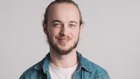 caucasian young man opening eyes on camera.