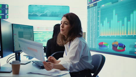 enterprise worker examines project updates and details in control room