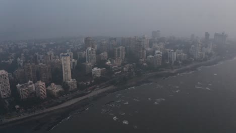 cinematic crane drone shot of mumbai coast bj road bandstand hazy