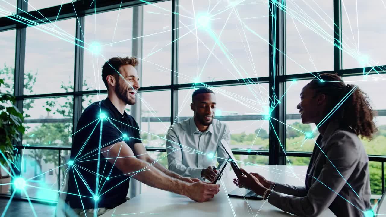 High-angle shot of three people in an office, surrounded by digital network lines