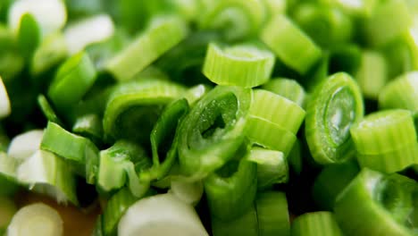 chopped scallions on chopping board 4k