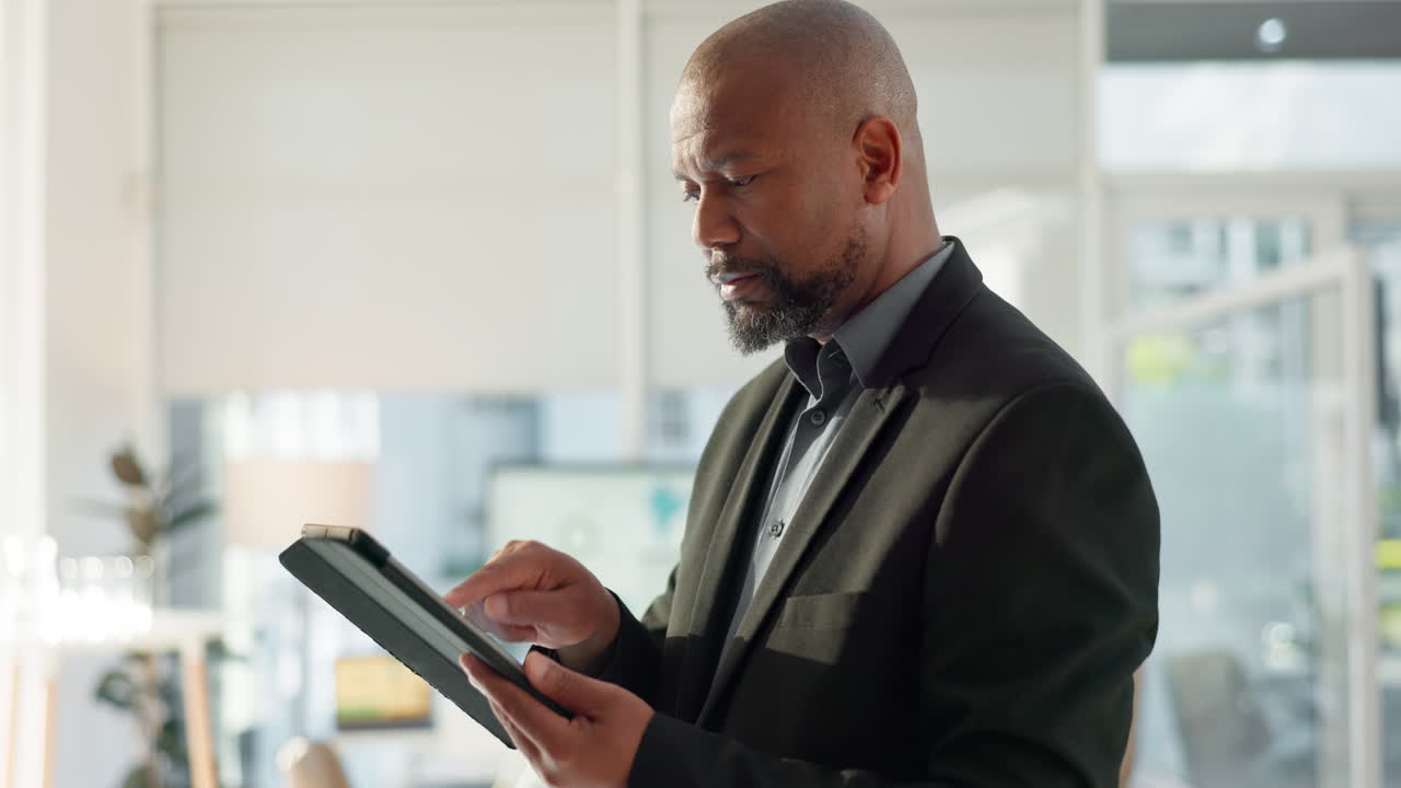 Black man in office with tablet