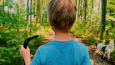 Immerse-yourself-in-the-enchanting-beauty-of-the-German-forest-as-a-young-boy-enjoys-a-leisurely-walk-with-his-faithful-canine-companion