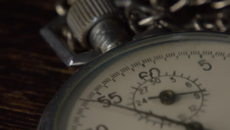 stopwatch on a dark wooden tabl