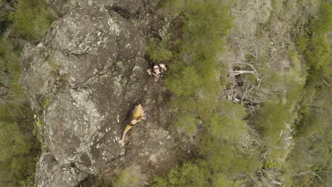 aerial flight above two people hiking on a trail path at border ranges national park, new south wales australia