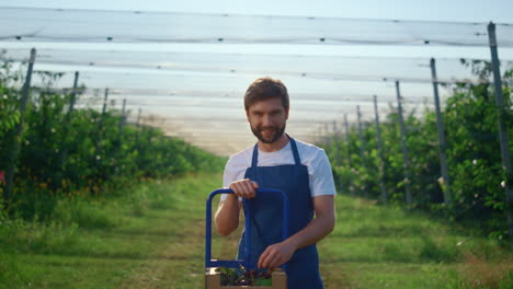 attractive farmer holding cherry at outdoors plantation. farm concept.