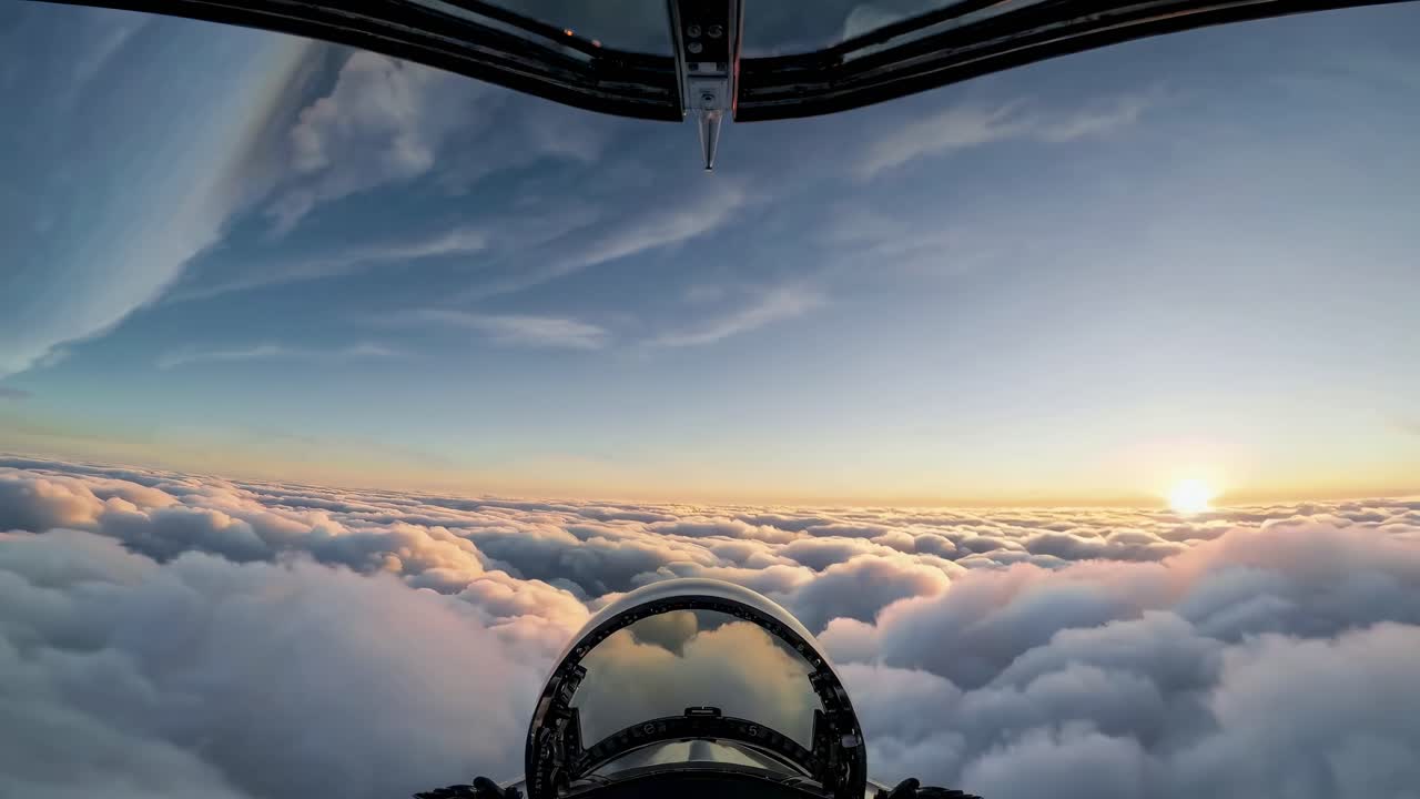 Aerial video shot from a cockpit perspective, capturing a stunning sunset above the clouds