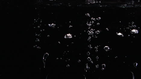 Slow-Motion-Male-Glasses-Drop-in-Water-with-Bubbles-Lost-Forever