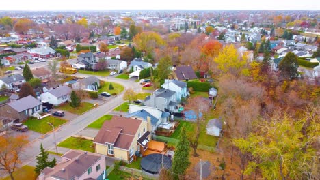 autumn suburban neighborhood with houses and trees on vibrant fall colors of estrie region, quebec, canada.