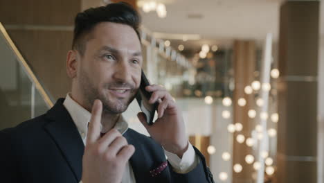 Businessman on Phone in Modern Office Lobby