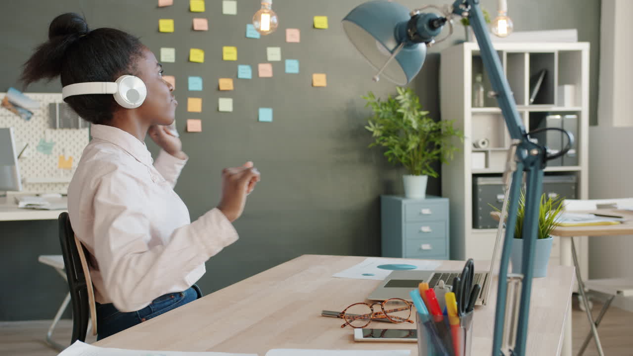 Woman enjoying music in the office