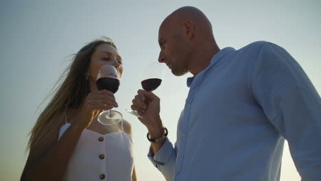 couple drinking wine and looking at each other