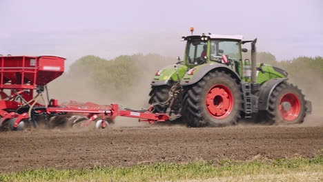 agriculture tractor in field. farming machinery working on plowed field