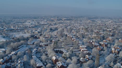 wide aerial establishing shot of nottingham england covered in a blanket of snow, housing market freeze concept shot