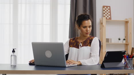 business woman working on laptop from home office