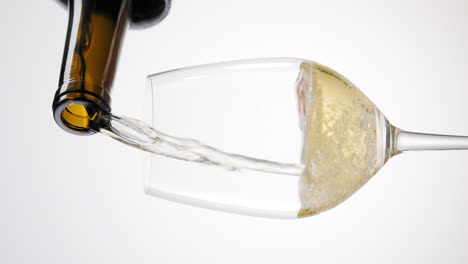 pouring a glass of white wine or champagne - vertical orientation