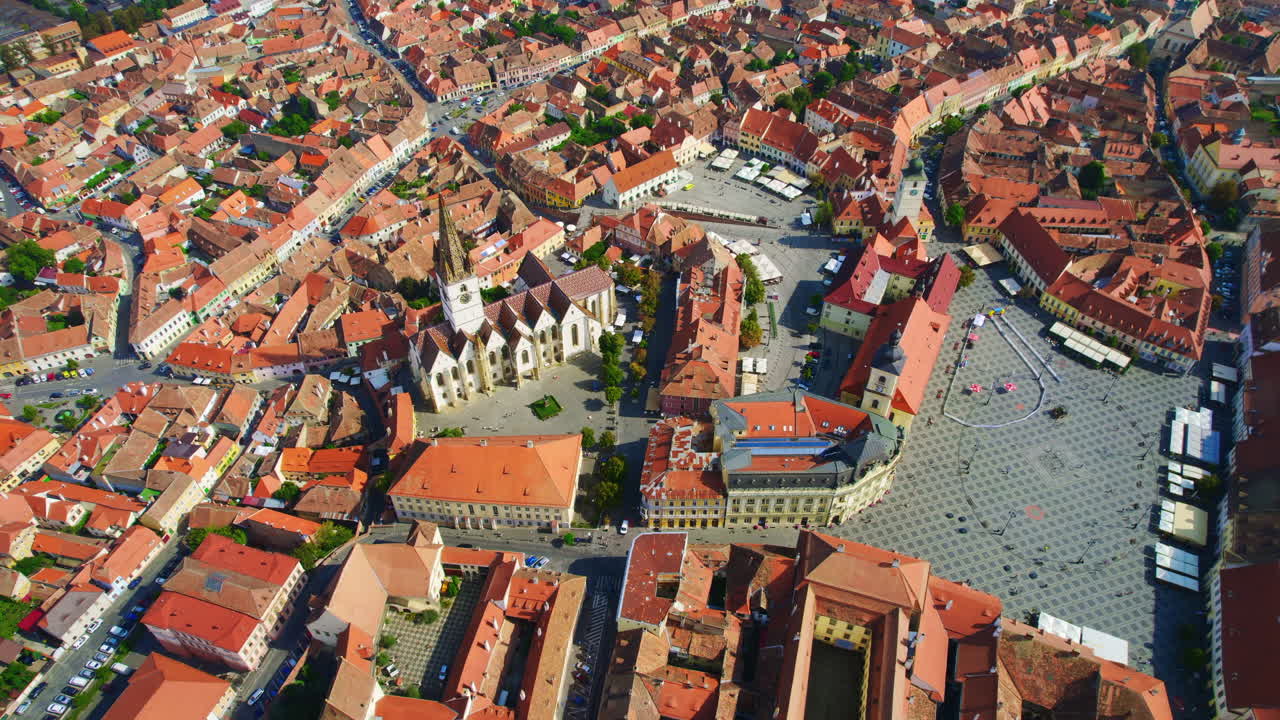 Aerial drone view of the Historic Centre of Sibiu, Romania. The Great Square with Sibiu Lutheran Cathedral and old buildings around, narrow streets