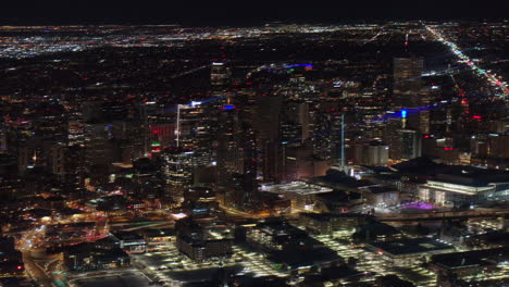 denver downtown aerial drone snowy winter evening dark night city lights landscape colorado cinematic anamorphic sky scrapers pan right circle zoomed in movement