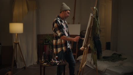 artist painting in home studio