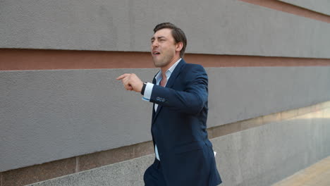 Side-view-businessman-dancing-outdoor.-Businessman-celebrating-victory-at-street