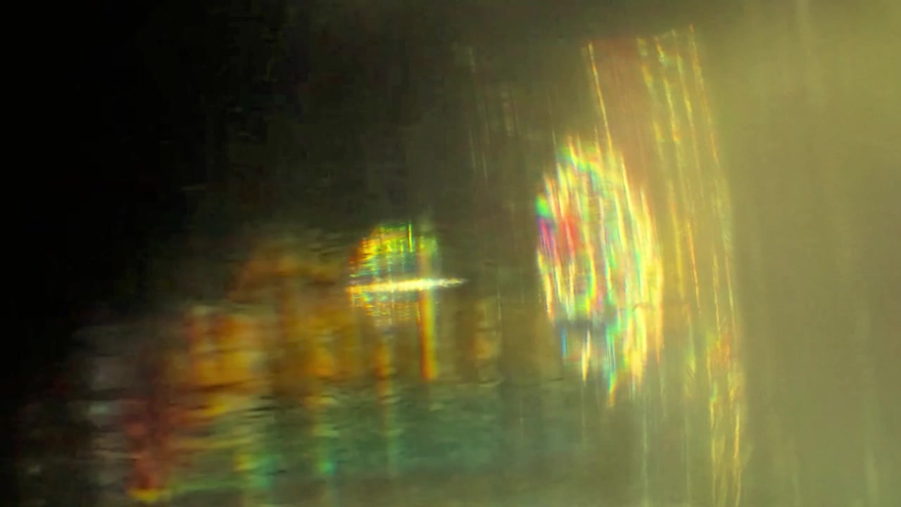 Abstract Light Leaks and Prism Reflections on Dark Background