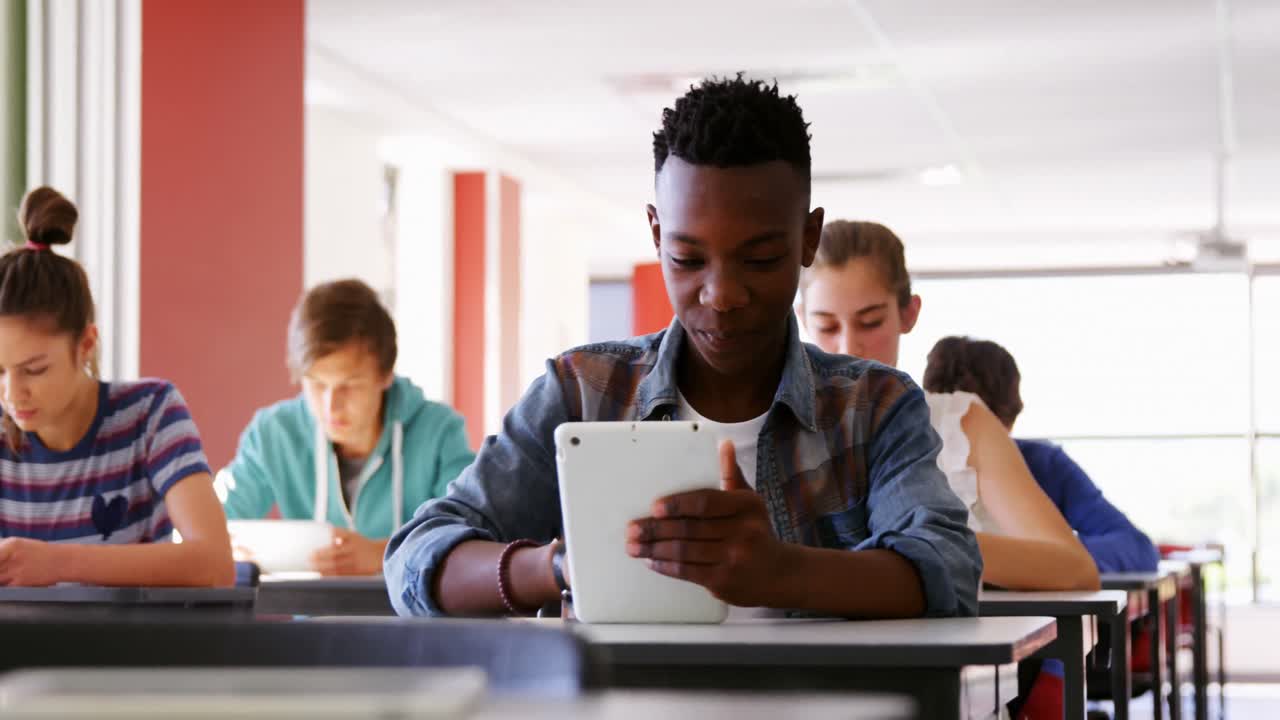Students using digital tablets in classroom