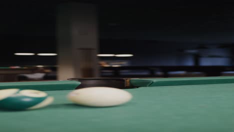 pool table with balls in a dark room