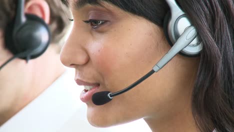 Smiling-ethnic-businesswoman-with-headset-on